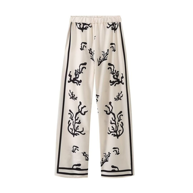 Elegant printed shirt and trousers set
Black and white co-ord for women
Stylish wide-leg pants outfit
Chic vacation outfit for women
Long-sleeve button-down shirt set
Trendy two-piece matching set