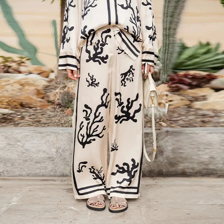 Elegant printed shirt and trousers set
Black and white co-ord for women
Stylish wide-leg pants outfit
Chic vacation outfit for women
Long-sleeve button-down shirt set
Trendy two-piece matching set