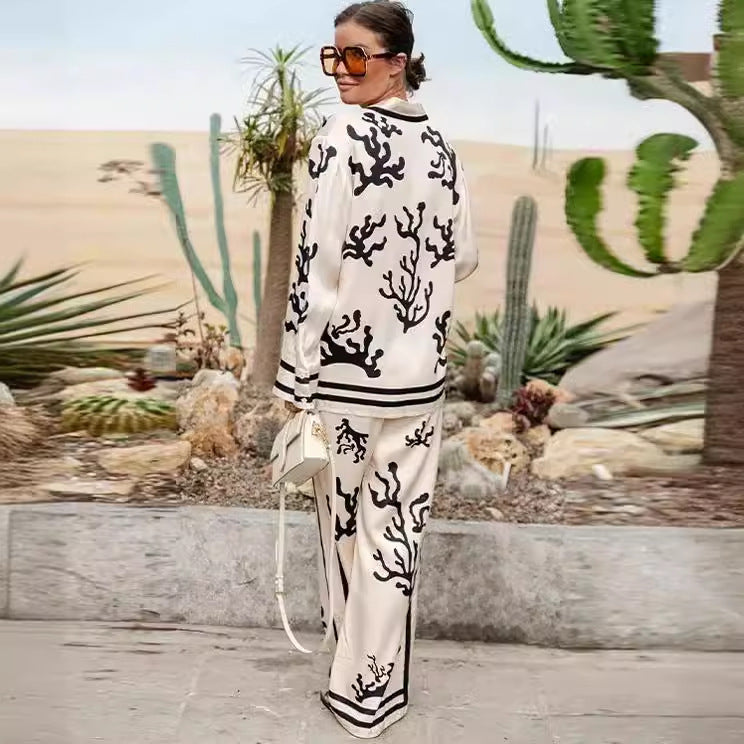 Elegant printed shirt and trousers set
Black and white co-ord for women
Stylish wide-leg pants outfit
Chic vacation outfit for women
Long-sleeve button-down shirt set
Trendy two-piece matching set
