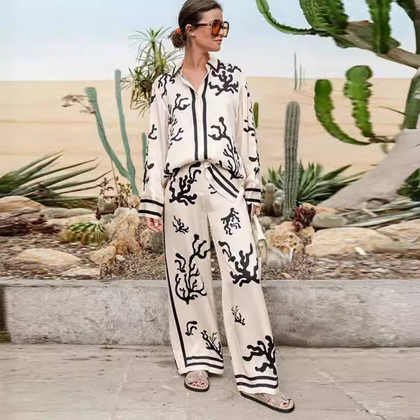 Elegant printed shirt and trousers set
Black and white co-ord for women
Stylish wide-leg pants outfit
Chic vacation outfit for women
Long-sleeve button-down shirt set
Trendy two-piece matching set
