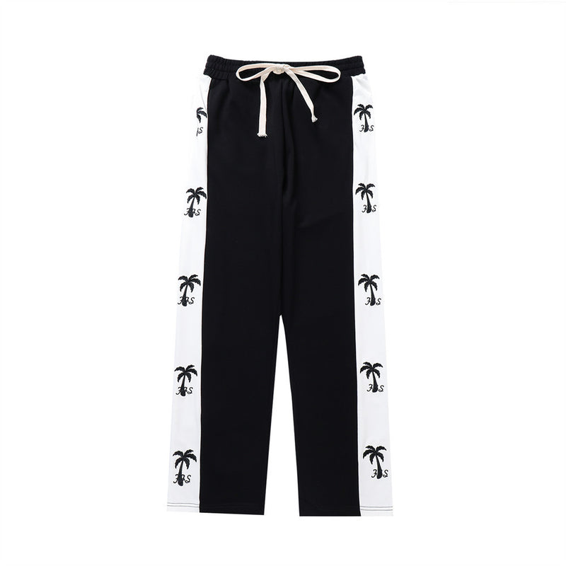 track pants, athleisure pants, casual style, streetwear, palm tree print, side stripe, relaxed fit, men's fashion, tropical design, trendy pants, comfortable fit, breathable fabric, lounging pants, versatile pants, everyday wear, island-inspired, soft fabric, stylish track pants, athletic-inspired, men’s casual pants, bold stripe, cool outfit, men’s wardrobe essential, statement pants, urban fashion