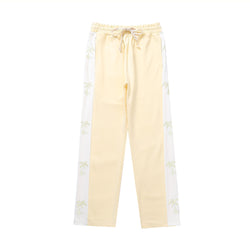 track pants, athleisure pants, casual style, streetwear, palm tree print, side stripe, relaxed fit, men's fashion, tropical design, trendy pants, comfortable fit, breathable fabric, lounging pants, versatile pants, everyday wear, island-inspired, soft fabric, stylish track pants, athletic-inspired, men’s casual pants, bold stripe, cool outfit, men’s wardrobe essential, statement pants, urban fashion